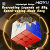 A close-up view of a MoYu RS3M V5 3x3 magnetic speed cube with white and blue faces, displayed against a dark background.