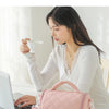 A woman is shown using an insulated lunch bag while enjoying food, demonstrating the convenience of delicious food always bei
