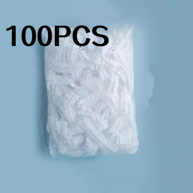 A bag containing 100 pieces of disposable transparent shower caps for hair dyeing and bathing.
