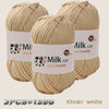 Three skeins of light beige or khaki colored acrylic yarn labeled Milk cot skin-friendly for knitting and crochet