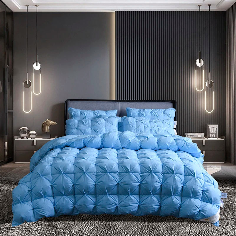 A light blue quilted duvet and pillows displayed on a bed in a modern bedroom setting.