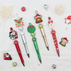 A craft kit featuring a beaded ballpoint pen and various Christmas-themed beads like reindeer and snowflakes.