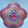 A colorful, multi-layered plastic balance stepping stone designed for kids' sensory and motor skills training.
