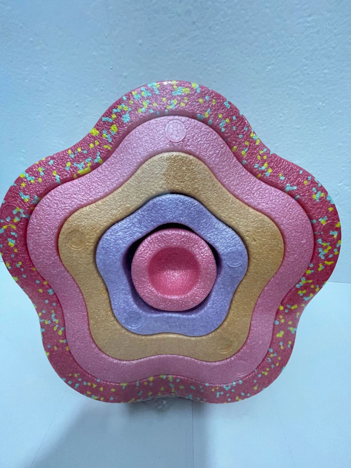 A colorful, multi-layered plastic balance stepping stone designed for kids' sensory and motor skills training.