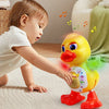 A baby is interacting with a yellow, interactive dancing duck toy that emits lights and music on a light-colored rug.