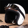 A white retro foldable motorcycle goggle is shown on a wooden surface.