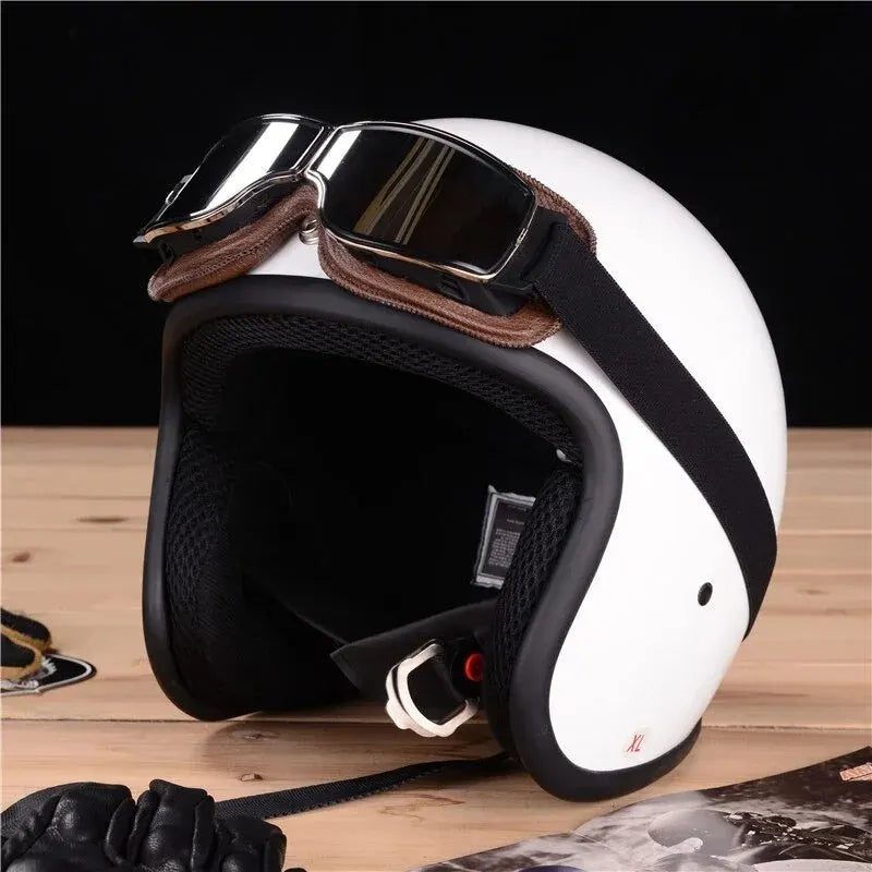 A white retro foldable motorcycle goggle is shown on a wooden surface.