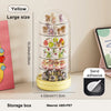 A tall, clear acrylic storage box with multiple tiers displaying small collectibles and keepsakes.