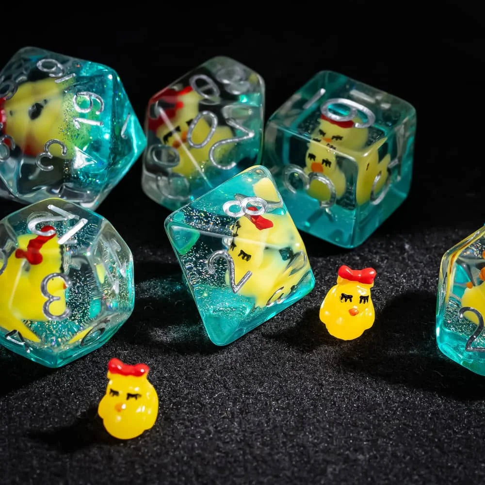 A collection of translucent teal resin dice shaped like yellow animals for tabletop role-playing games