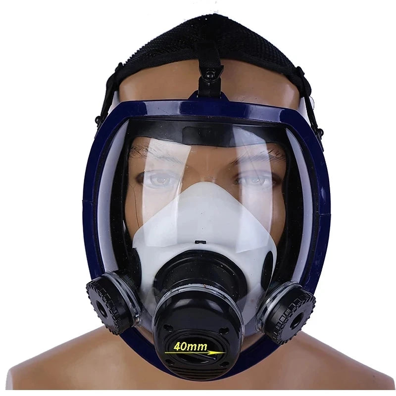A full face respirator mask with a clear visor and white filter is shown on a mannequin head.