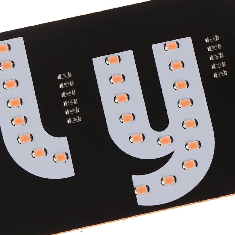 A black circuit board with a large letter U made of white LED lights and small indicator LEDs.