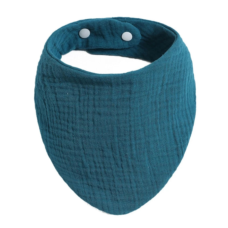 A teal organic cotton muslin baby bib with an absorbent band around the neck.