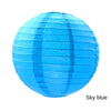 A bright sky blue round paper lantern.
