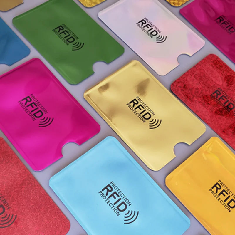 A collection of colorful RFID blocking aluminum card holders in various shades including green, pink, yellow, and blue.