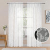 White sheer curtains with vintage floral lace pattern hanging in a window.