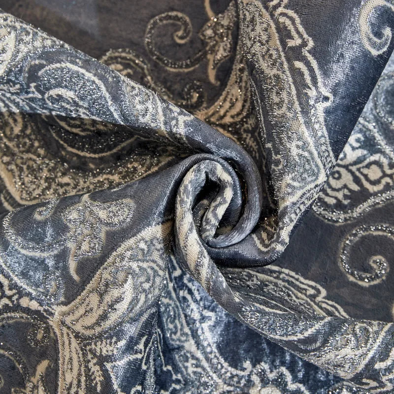 A dark blue and silver patterned fabric, likely a sofa cover, is folded and draped.