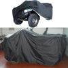 A black heavy duty storage cover is placed over an ATV quad bike.