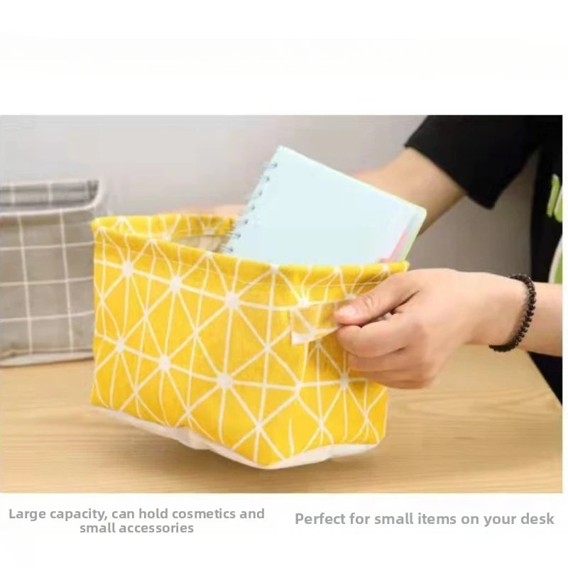 Yellow patterned storage basket with handles holding cosmetic items on a wooden desk.
