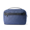 A dark blue waterproof travel toiletry bag with a black handle and a black name tag on the front.