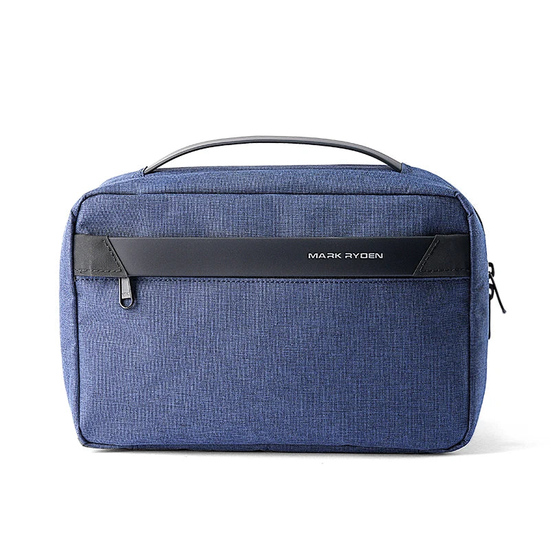 A dark blue waterproof travel toiletry bag with a black handle and a black name tag on the front.
