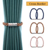 Set of two magnetic curtain tiebacks with rope buckle clasps in teal fabric.
