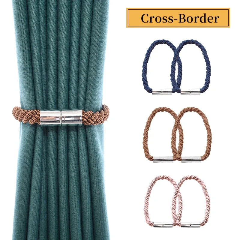Set of two magnetic curtain tiebacks with rope buckle clasps in teal fabric.