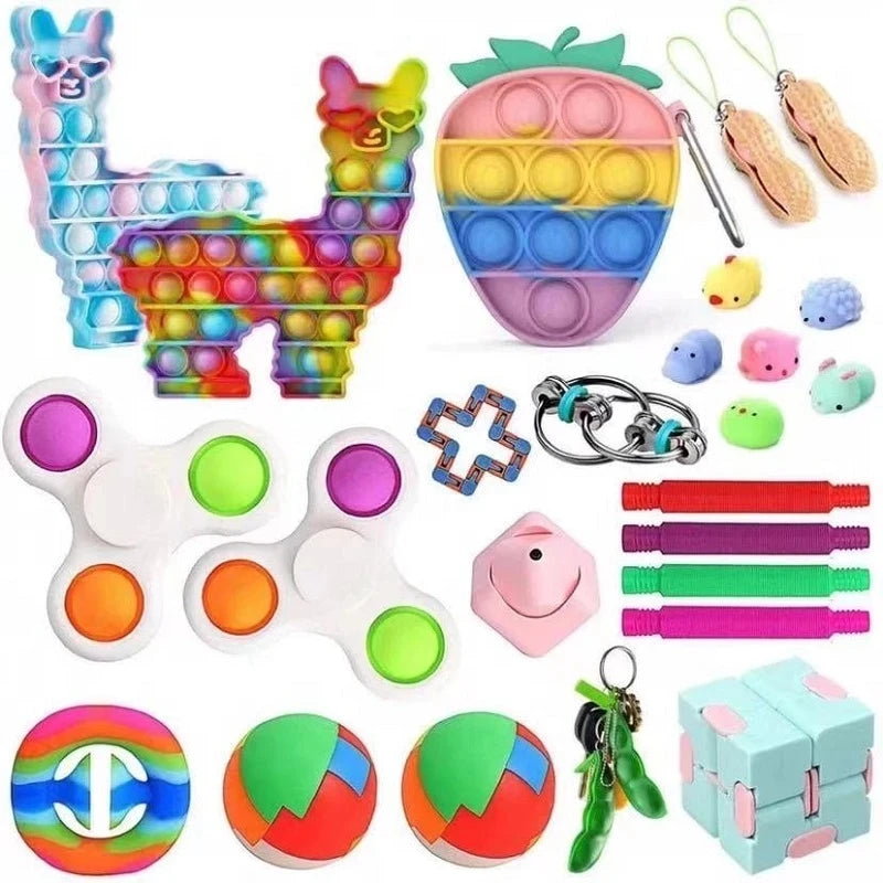A collection of colorful fidget toys including a Lego-style animal, various silicone stress balls, and a patterned sphere.