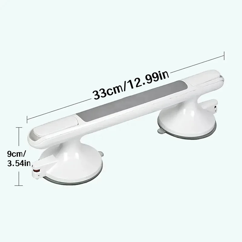 A white non-slip suction grab bar mounted on a wall, shown with dimensions 33cm/12.99in and 9cm/3.54in.