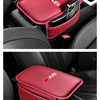 A red leather car armrest box with a storage pocket and the A6 logo placed in a car interior.