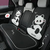 Black car seat covers featuring panda designs and headrest pillows for a vehicle interior.