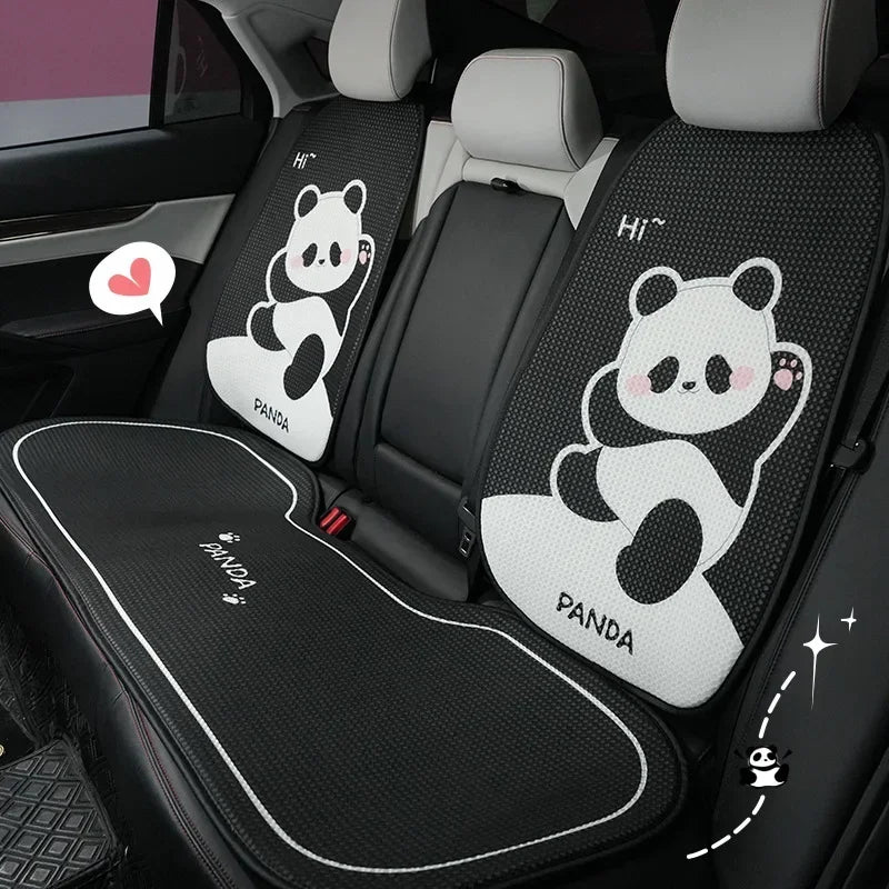 Black car seat covers featuring panda designs and headrest pillows for a vehicle interior.