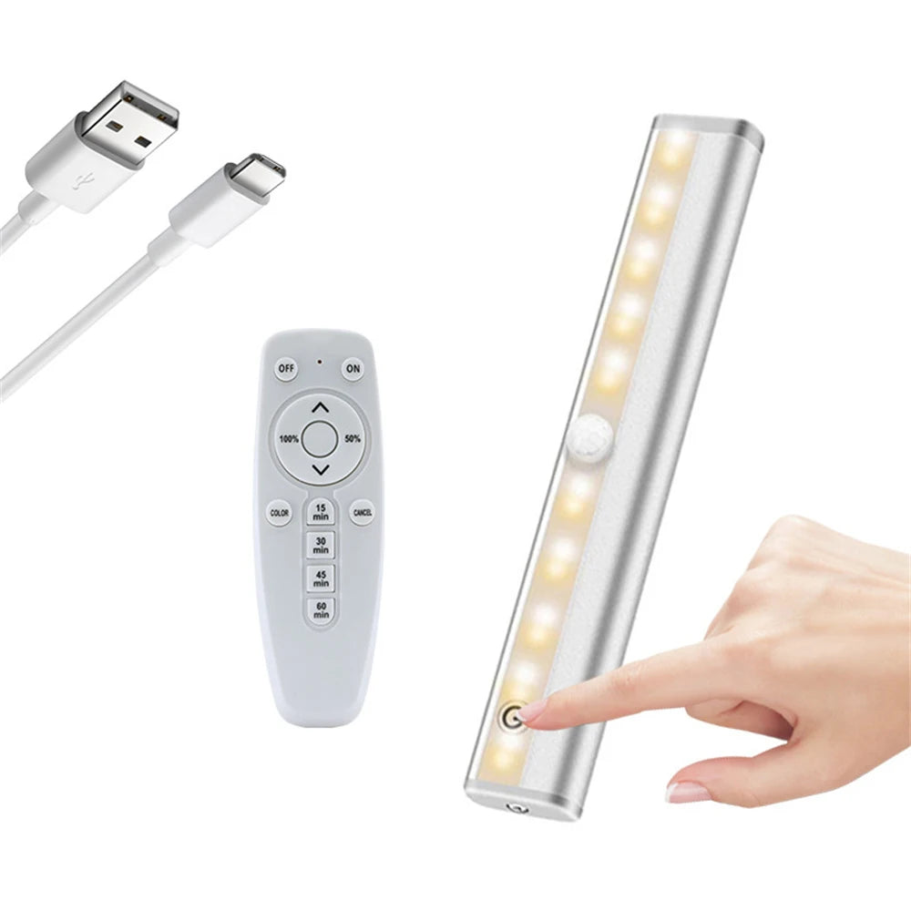 A rechargeable LED under-cabinet light fixture with a remote control and touch sensor being activated by a hand.