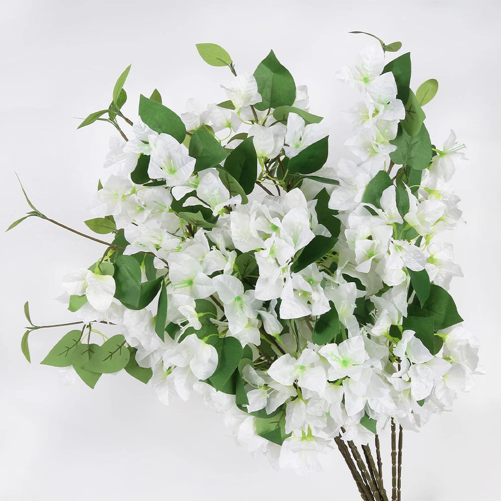 A bouquet of white artificial bougainvillea vine branches with green leaves.