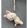 A soft, light orange K-pop character animal plush doll with pink ears hanging from a strap.