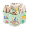 A light green rotating desk organizer holding numerous pens and writing supplies.