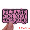 Pink embroidered iron-on patch with black text that reads Please do not talk to me