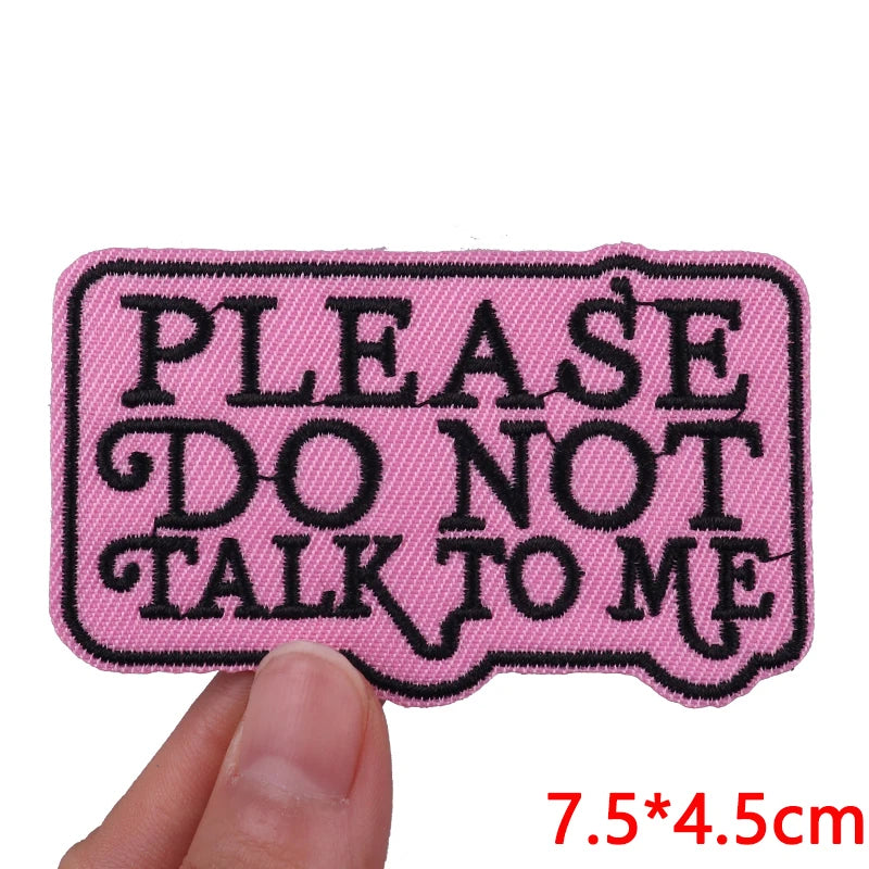 Pink embroidered iron-on patch with black text that reads Please do not talk to me