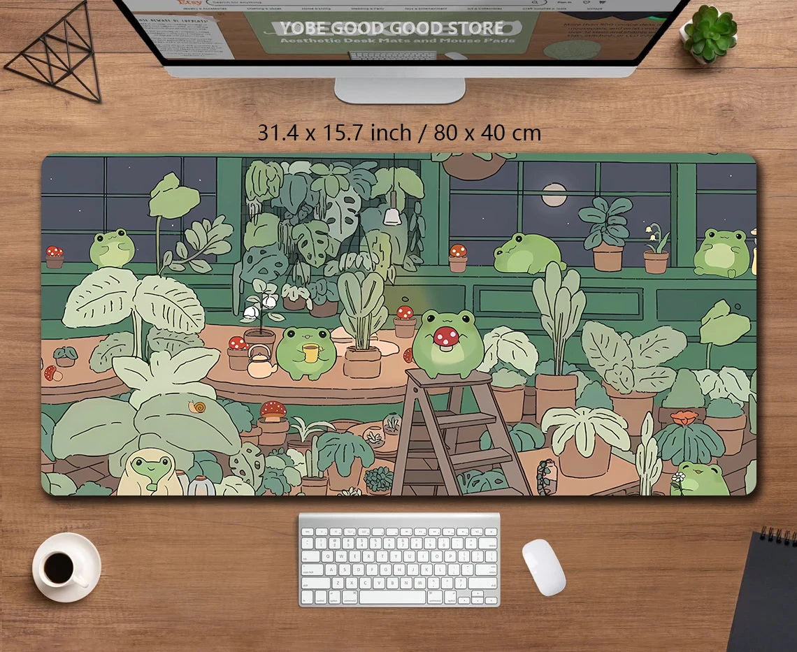 A large extended desk mat featuring a kawaii nature design of frogs and plants.
