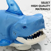 A blue plastic interactive swaying shark toy with an open mouth showing teeth and white gums.