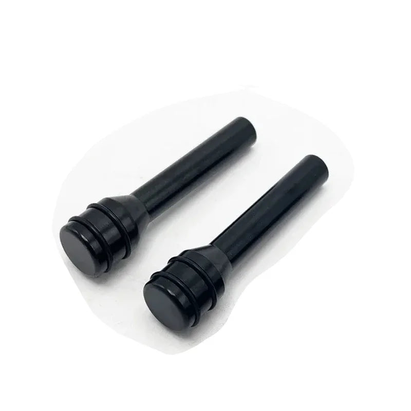 A pair of black aluminum alloy car door lock pins shown against a white background.