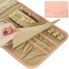 A beige foldable waterproof jewelry roll with decorative findings and a pink cosmetic pouch.