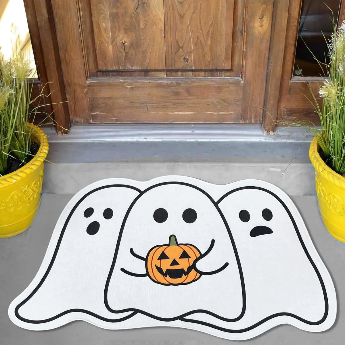 A white decorative rug featuring three ghost designs carved into an orange pumpkin on a gray surface.