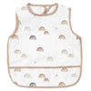 White waterproof full-body baby feeding bib with a sleeveless design featuring rainbow patterns