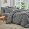 A gray three-dimensional pleated floral duvet cover set displayed on a bed.