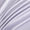 A close-up of a silky soft, light purple bamboo flat sheet draped in flowing folds.