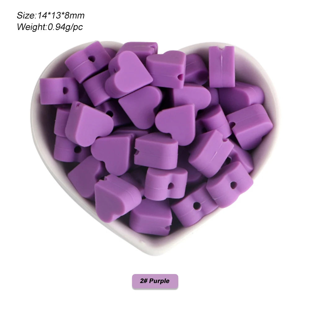 A pile of purple silicone crown star heart beads for DIY jewelry making