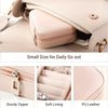 A light pink PU leather jewelry storage box with a zipper and soft lining shown open on a surface.