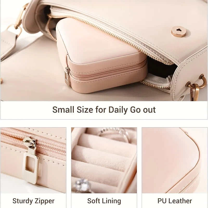 A light pink PU leather jewelry storage box with a zipper and soft lining shown open on a surface.