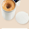 A white mug filled with coffee is shown next to a magnetic induction automatic stirring device.