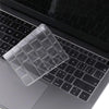 A clear silicone keyboard cover is placed on a black MacBook keyboard.